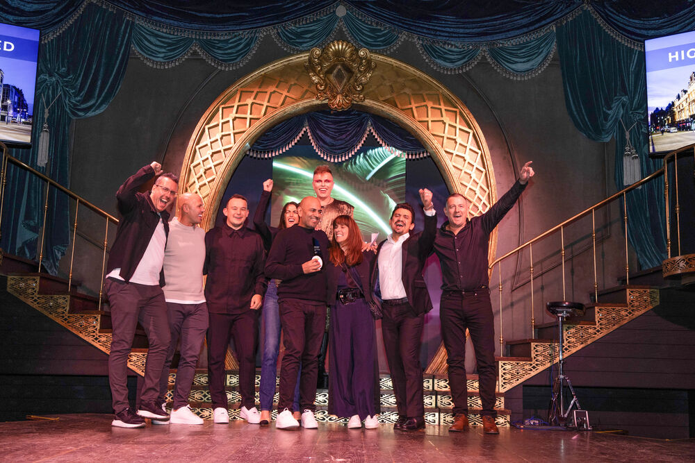 A winning team celebrates on stage